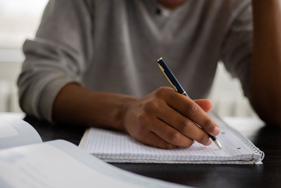 Student working through maths problems at a desk